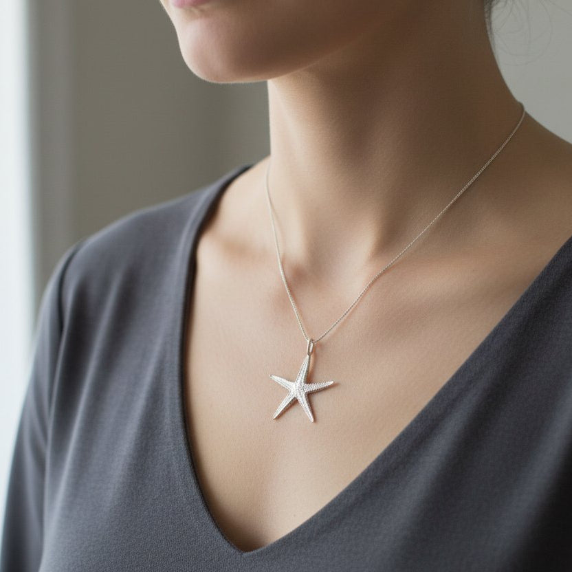 Starfish Pendant Necklace - bright sterling silver handcast pendant on thin silver chain, worn by model 