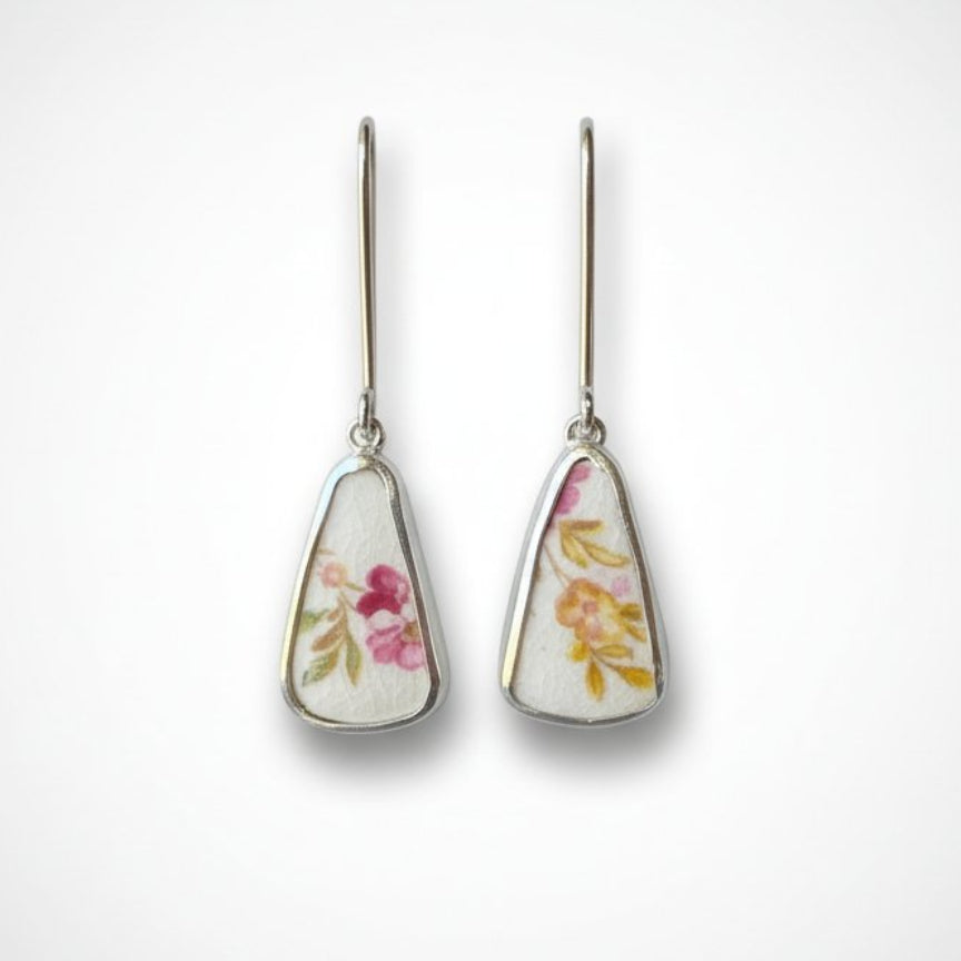 Broken china tea cup drop earrings - sterling silver setting with Tuscan Windsor floral bone china - displayed on antique tea cup