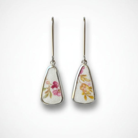 Broken china tea cup drop earrings - sterling silver setting with Tuscan Windsor floral bone china - displayed on antique tea cup