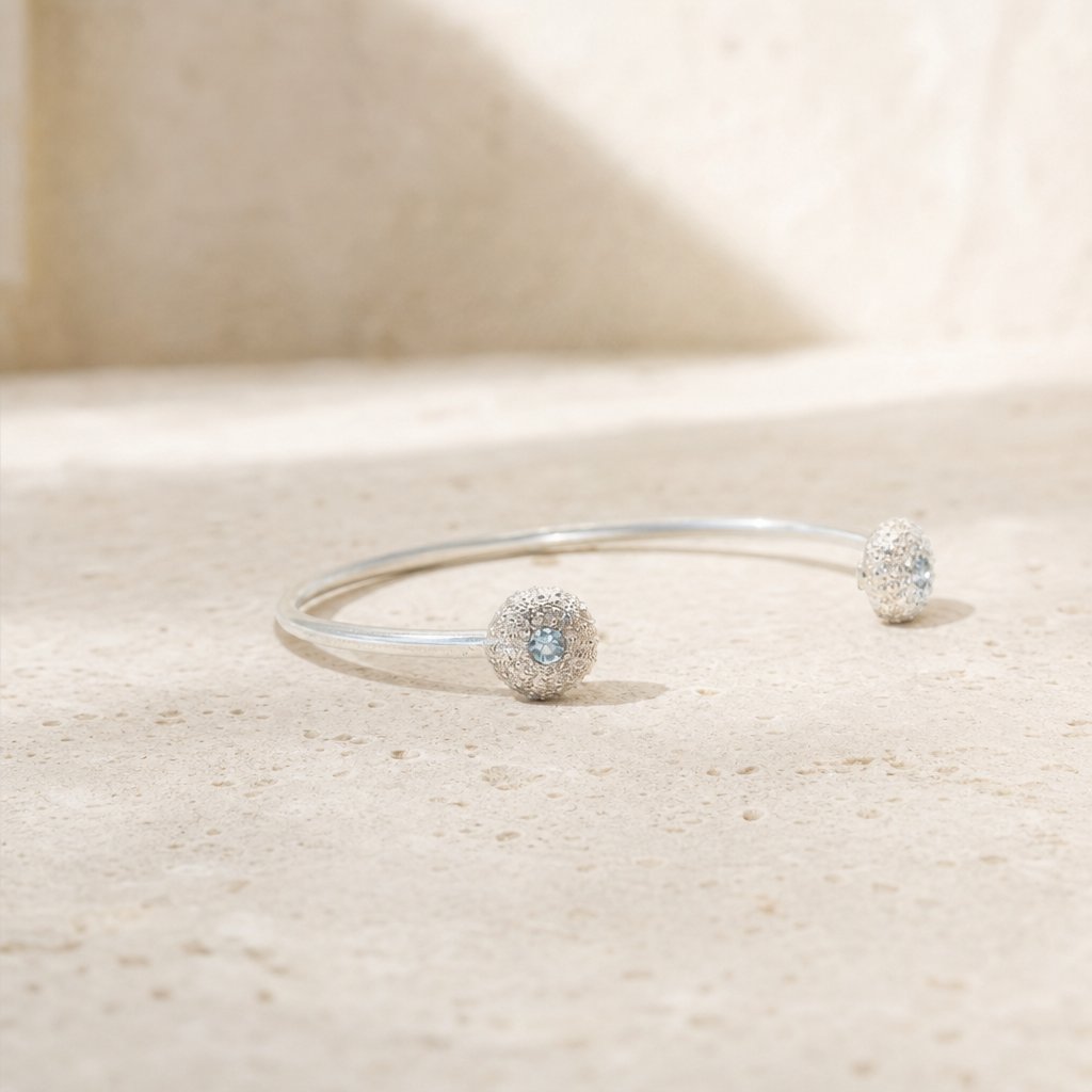 The Sea Urchin Bangle - close-up of sea urchin end with Blue Topaz gemstone, sterling silver texture detail