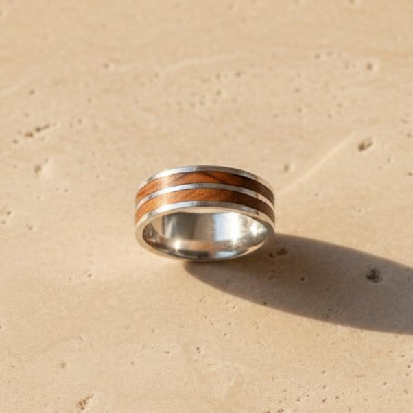 Layered olive wood and sterling silver ring - angled side view showing 9mm banded wood and silver contrast