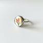 Yellow Flower Ceramic Ring - worn on hand showing scale, sterling silver band with antique ceramic centre