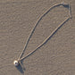 medium Sea Urchin Pendant - full sterling silver necklace laid on beach sand, lifestyle