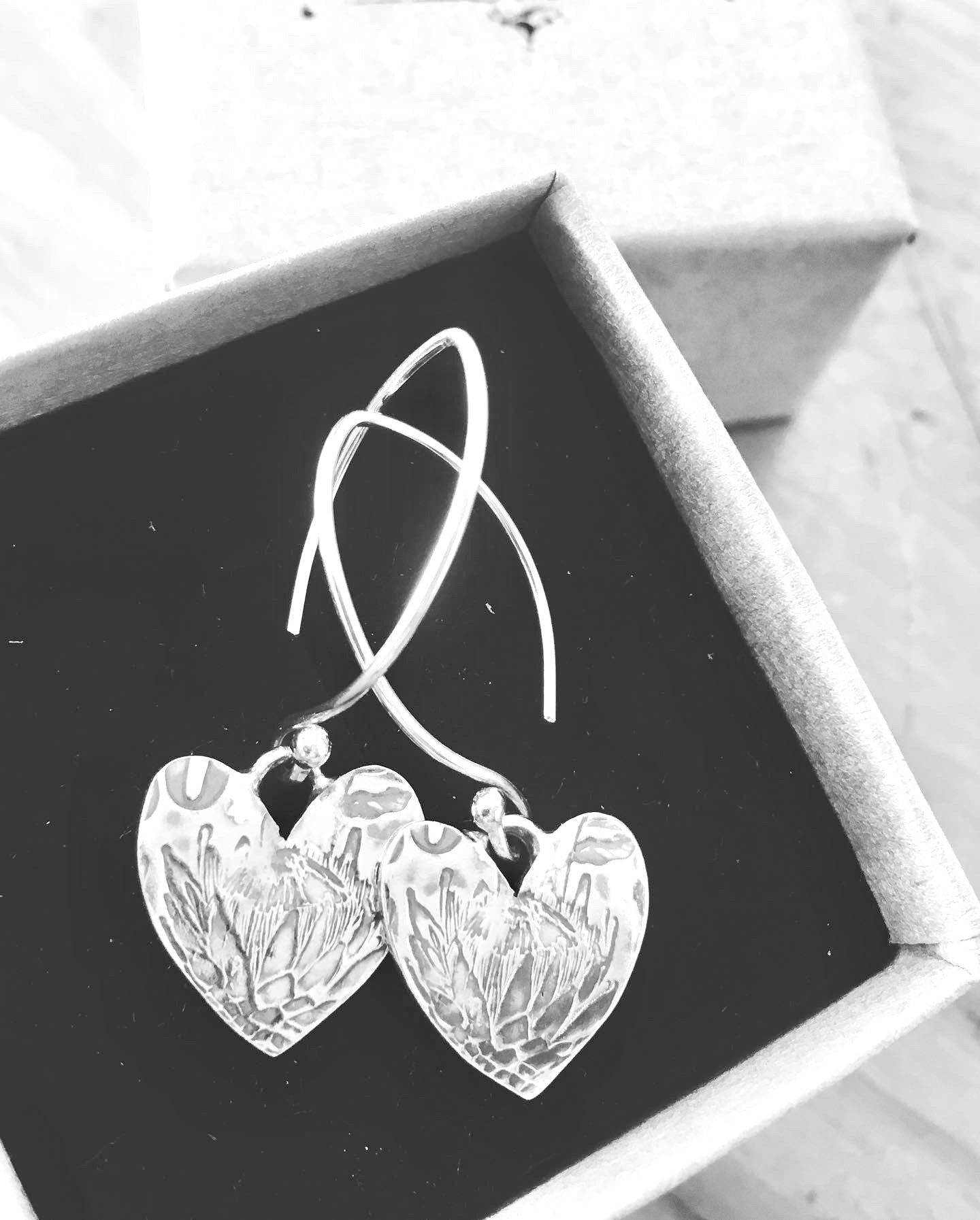 Sterling silver Protea Heart earrings showcased in an elegant box, perfect for gifting