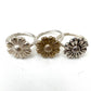 Variety of Daisy Flower Rings in brass, oxidised, and plain silver on display, demonstrating different color options.