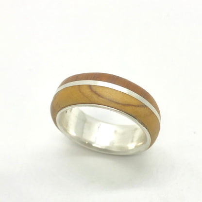 Close-up of the comfortable interior fit of the double-layer silver band with olive wood.