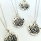 Silver Protea Disc Pendant - front view of oxidised King Protea illustration on handcrafted sterling silver disc, 925 silver chain