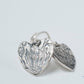 Worn view of medium-sized Protea Heart hook earrings, accentuating their fit and style.